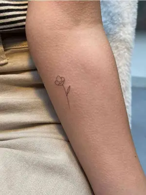 forearm with flower tattoo