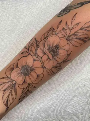 forearm with flower tattoo