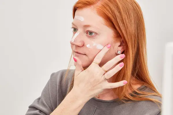 Person applying the MDSolar Sciences Daily Perfecting Moisturizer on their face