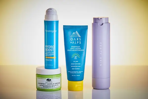 Four different bottles of moisturizers with SPF