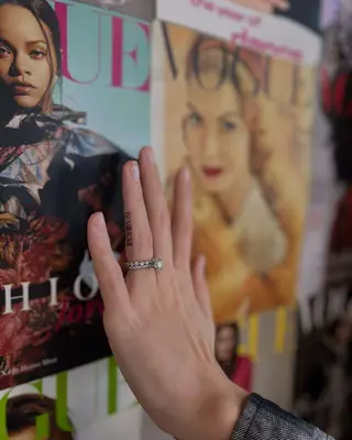 Person with hidden Roman numeral ring finger tattoo