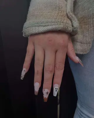 Person with cross ring finger tattoo