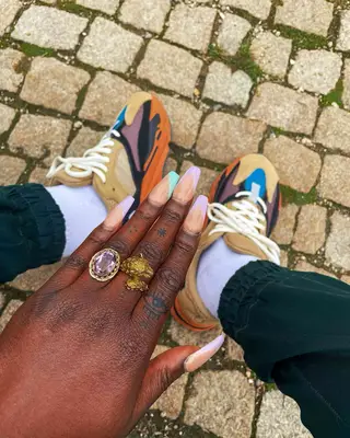 Person with a mix-and-match finger tattoos