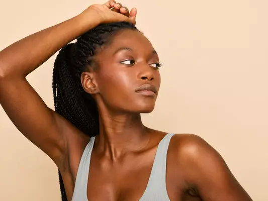 A woman holding her arm above her head