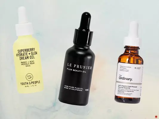 A collage of anti-aging facial oils from Youth to the People, Le Prunier, and The Ordinary we recommend on a light blue background