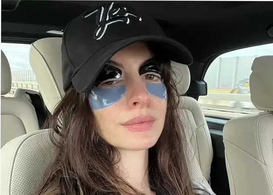 close up of anne hathaway in the car wearing eye gels