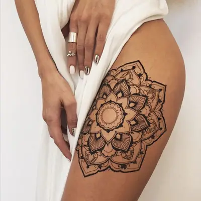 Mandala tattoo on the outer thigh