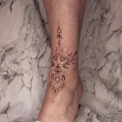 Ornate pattern ankle tattoo