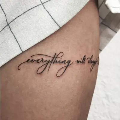 Quote tattoo on the side of the thigh