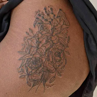 Floral line art leg tattoo