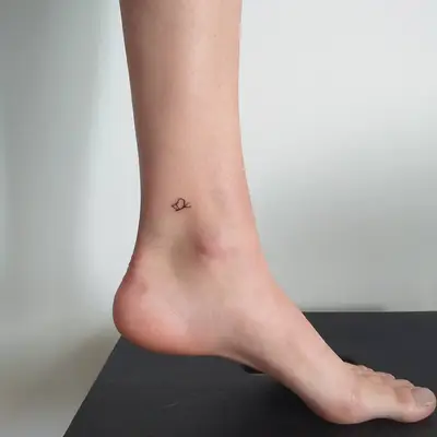 Small butterfly outline leg tattoo