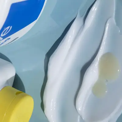 Swatches of hydrating skincare products on a blue background