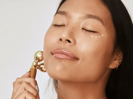 woman with eye cream around her under-eye