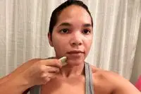 Person using the Ginger Chi Jade Gua Sha Face & Comb Tool on their face