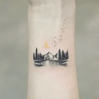 Close up of a tree and solar system tattoo