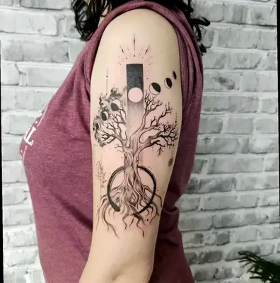 Bare tree with moon phases tattoo
