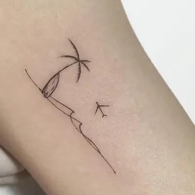 Palm tree with surfboard on beach with plane line tattoo