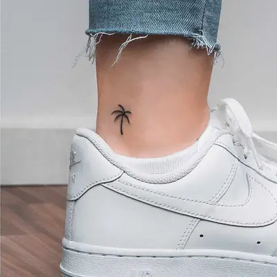 Tiny palm tree tattoo on ankle