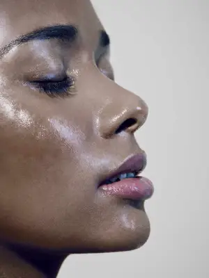 Woman with damp face and closed eyes