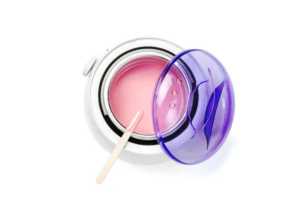Pink wax melted in a wax pot
