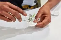 Hand dispensing Simple Kind to Skin Micellar Cleansing Water onto a cotton round