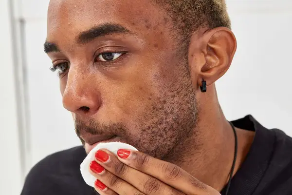 Person using cotton round on chin