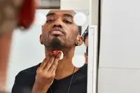 Person using cotton round on neck