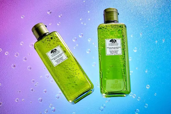 Origins Mega-Mushroom Skin Relief Micellar Cleanser displayed on a colorful surface