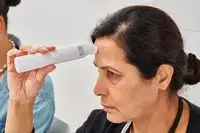 Person using a hydration meter on their forehead