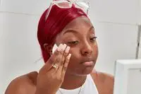 Person applying Kumiko Skincare Matcha Micellar Water to their face
