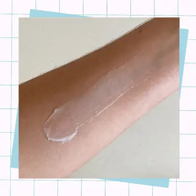 Aveeno Daily Moisturizing Lotion spread on the back of an arm 