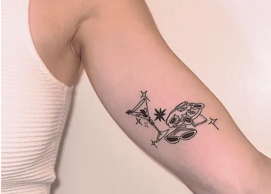 close up of martini and caviar tattoo on woman