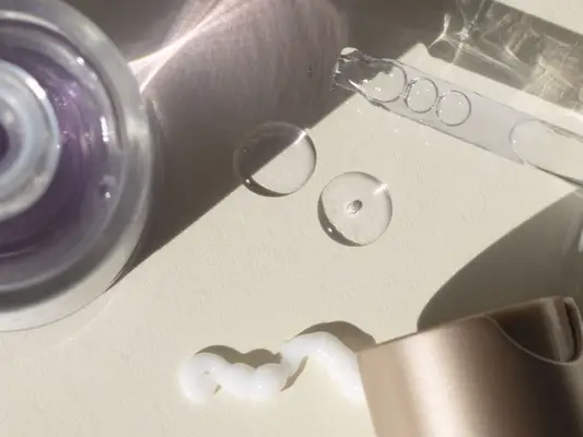 skincare creams and oils against a beige backdrop