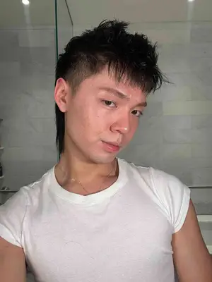 An editor wearing a gold face mask while getting a facial with silver cold face globes