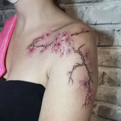 Large cherry blossom branches shoulder tattoo
