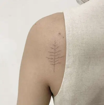 Upright bare tree shoulder tattoo