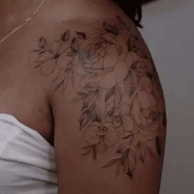 Shoulder tattoo with flower and leaf line art design