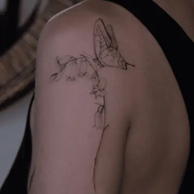 Outline paper bird airplane shoulder tattoo