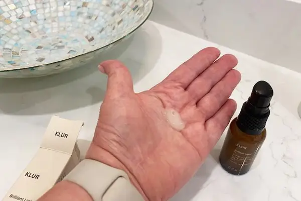 Dollop of Klur Brilliant Light Multi-Correctional Repair Serum in the palm of a hand