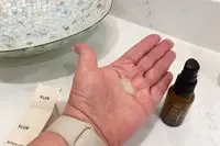 Dollop of Klur Brilliant Light Multi-Correctional Repair Serum in the palm of a hand