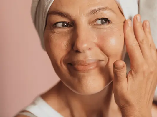 woman applying eye cream to eye area
