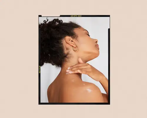 woman applying cream to neck