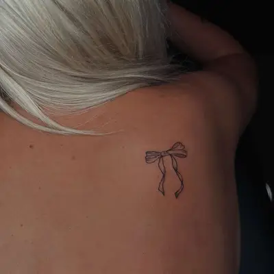 A bow tattoo on the shoulder
