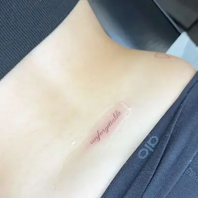 A script tattoo reading 