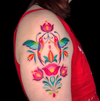 Multicolored rainbow colorblock tattoo of flowers and birds on bicep