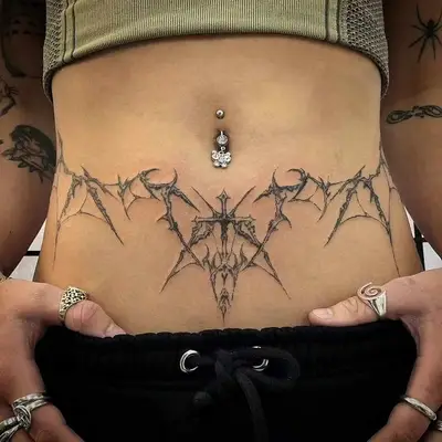 Close up of a forearm with an abstract, freehand tattoo of a flowing line