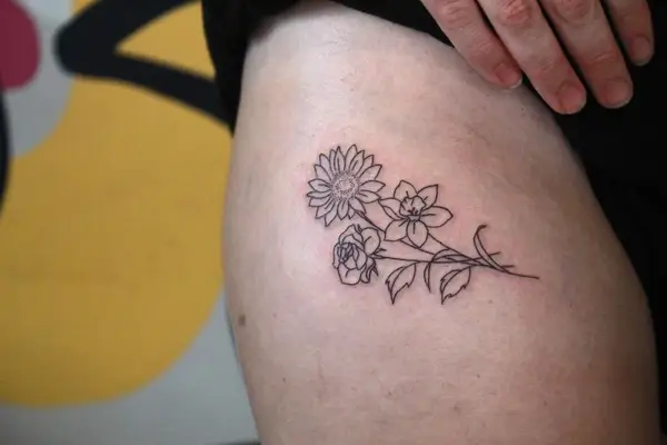 upper thigh sunflower tattoo