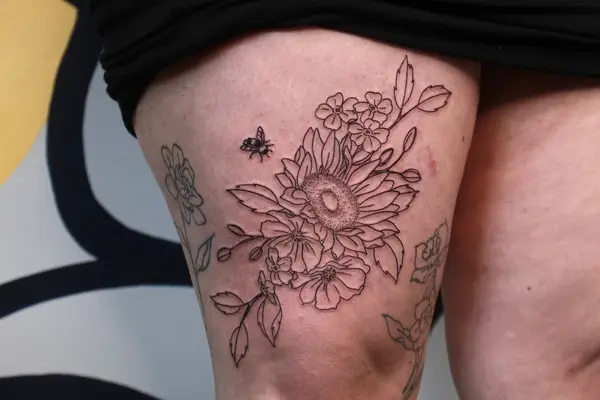 above the knee sunflower tattoo