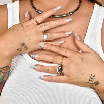 image of black ink fine line tattoos on fingers and hands, small in size