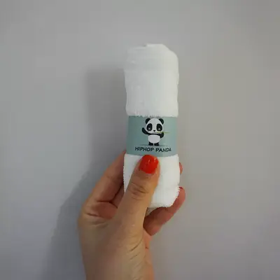 hand holding up HipHop Panda Bamboo Washcloths in packaging